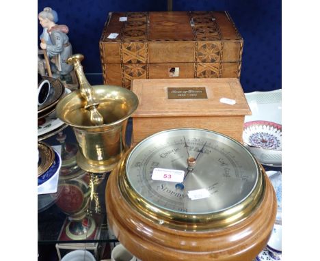 AN ANEROID BAROMETER by Negretti &amp; Zambra, a cigarette box made from wood from, 'The Rose of Devon 1869-1939' a brass mor