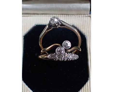 A DIAMOND CROSS-OVER RING, together with two other diamond rings, two ring size N, one ring size O, (3)