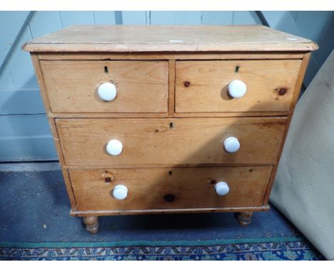 A VICTORIAN STRIPPED PINE CHEST OF DRAWERS with white ceramic knobs, 86cms wide