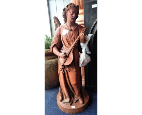 A MOULDED TERRACOTTA FIGURE OF AN ANGEL PLAYING A LUTE, 79cm high