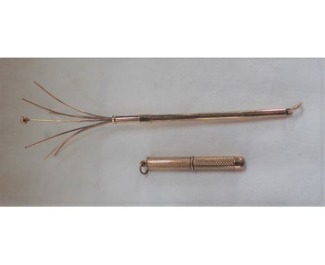 A 9CT GOLD SWIZZLE STICK and a similar miniature corkscrew, approximately 11gms