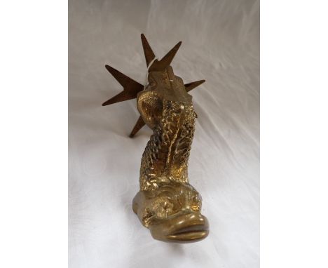 A HEAVY CAST BRASS DOOR KNOCKER in the form of a dolphin, on a Maltese cross