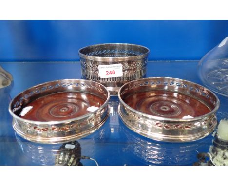 A PAIR OF SHEFFIELD PLATE AND TURNED MAHOGANY DECANTER COASTERS, LATE 18TH CENTURY, 13CM DIAMETER; AND ANOTHER SILVER PLATED 