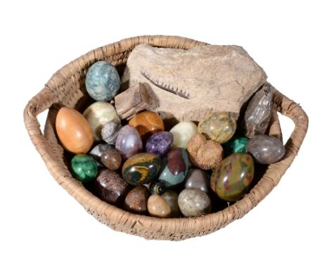  A collection of twenty-four polished hardstone and mineral specimen eggs,   including two malachite examples, three green on