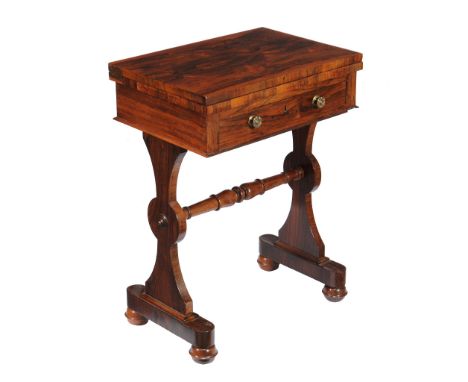 Ω An early Victorian rosewood games table , circa 1840, the hinged rectangular top opening to a baise lined playing surface a