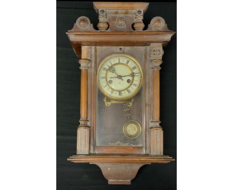 A Hamburg American Clock Company (HAC) Walnut cased Vienna wall clock, white enamel dial, black roman numerals, with pendulum