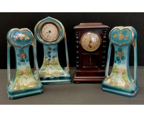 An Art Nouveau three piece clock garniture, decorated with Swans, turquoise ground, 29.5cm high;  wooden mantle clock. 