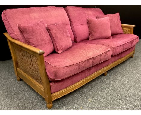 An Elm and Bergere weave deep sofa, plum upholstery cushions, approx. 89cm high x 191cm wide x 102cm deep. 