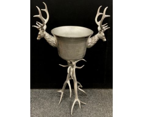 A large silver coloured metal ‘Stag’s head’ wine cooler/ice bucket, raised on a Stag Antler form tripod base, 103cm high. 