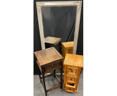 A narrow pine chest of drawers, over-sailing top, three drawers, stepped foot, 74cm high, 31.5cm wide, 30.5cm deep;  a staine