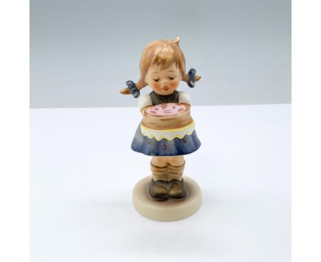 Figure of a girl with pig tails holding a cake. M.I. Hummel impressed. Goebel backstamp. 143/Hum 541. This item has its origi