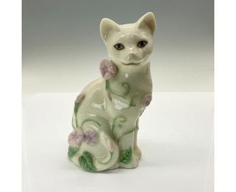 Sweet seated cat decorated with pink flowers. She is handcrafted from ivory china, and painted and finished with a crackle gl