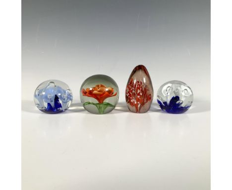 Beautiful collection of floral themed glass paperweights. Two are designed by Joe St. Clair, one with light blue flowers, the
