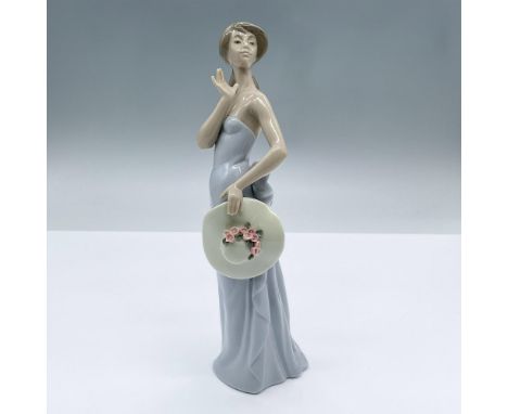 Lovely glossy figure of a lady in a sleek light blue dress holding a sun hat. This item has its original box measuring 11"L x