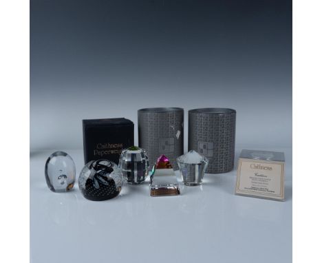A collection of five exquisite paperweights including a round cauldron inspired design, a Swarovski barrel and pyramid with r
