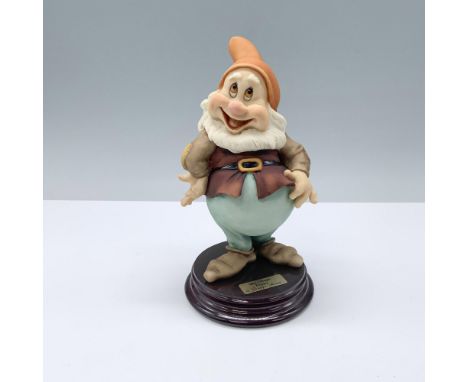 Handcrafted figurine in matte finish featuring Happy, one of the beloved seven dwarfs from Disney. The character is depicted 