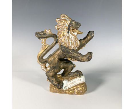 A hand-painted figural sculpture of a standing lion, accented with gilt details, featuring the words Dieu et mon droit (God a