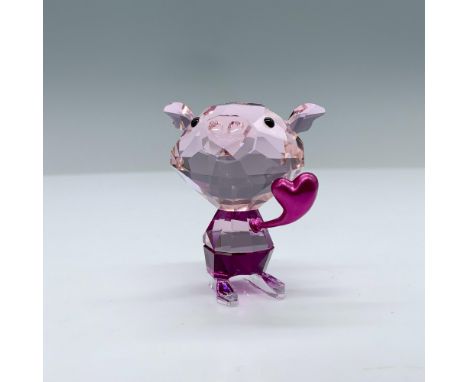 Crafted in red crystal, this little pig spreads love with fuchsia pant and clear crystal feet. The piece is finished with a h