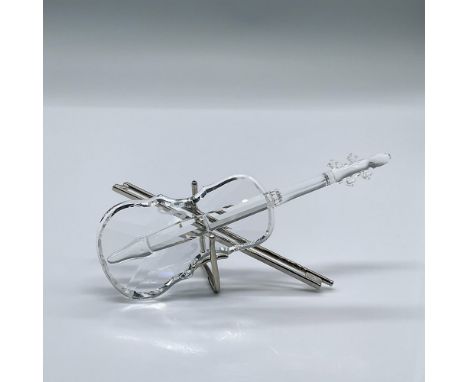 This charming clear crystal violin comes with a rhodium metal bow and stand. This item has its original box measuring measuri