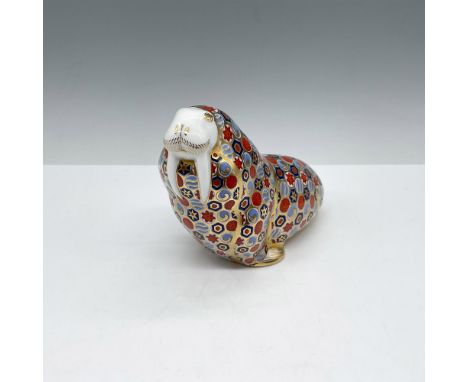 The majestic hand painted, colorful figure sits with tusk prominently displayed. Colored in sienna, blue, and gilt incorporat