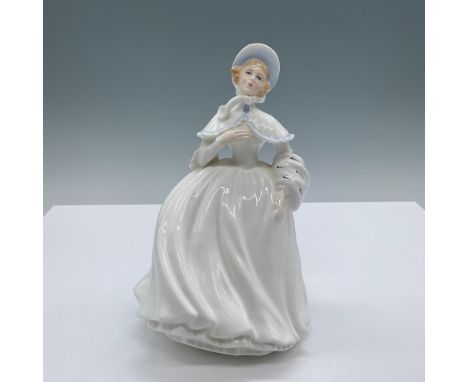 A woman in a white dress with light blue stitching accents and a matching bonnet places her hand over her heart as her dress 