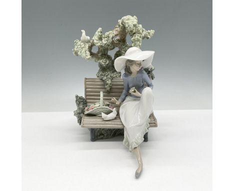 Lovely figure sitting on a bench with doves and a basket of flowers. Colored in green, blue, white and pink. Lladro backstamp