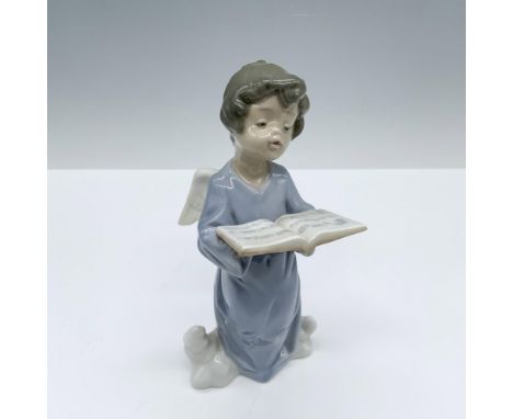 Glossy figure of a winged angel standing on a cloud as he sings melodies from a songbook. Lladro backstamp. This item has its