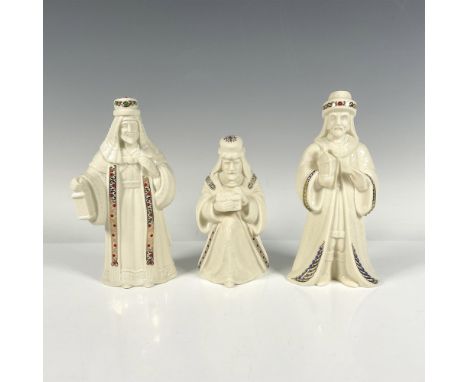 Three elegant white figurines of the wise men, each adorned with gilded accents and jewel like patterns, exuding an air of re