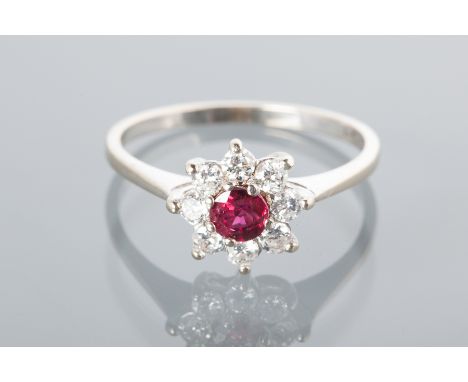 RUBY AND DIAMOND CLUSTER RING
with a central round ruby surrounded by brilliant cut diamonds, marked 750 for eighteen carat g