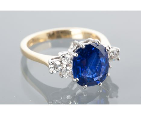 SAPPHIRE AND DIAMOND DRESS RING
set with a cushion shaped sapphire of approximately 4.71 carats flanked by two groups of thre