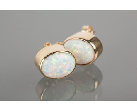 PAIR OF NINE CARAT GOLD CREATED OPAL STUD EARRINGS
each set with an oval created opal 9mm long, in nine carat gold