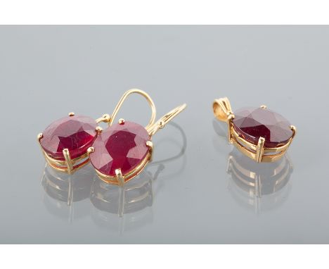 EIGHTEEN CARAT GOLD RUBY SET DROP PENDANT 
set with a large oval faceted stone; along with a pair of similar drop earrings wi