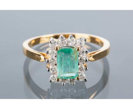 EMERALD AND DIAMOND CLUSTER RING
the central emerald cut emerald 7x5mm surrounded by round diamonds, in fourteen carat gold, 