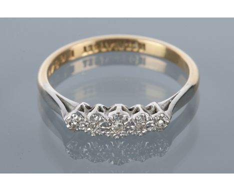 MID TWENTIETH CENTURY DIAMOND FIVE STONE RING
the round diamonds in illusion settings, in platinum, on an eighteen carat gold