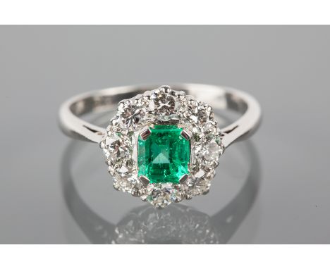 EMERALD AND DIAMOND CLUSTER RING
the emerald cut emerald approximately 0.62 carats, surrounded by brilliant cut diamonds tota