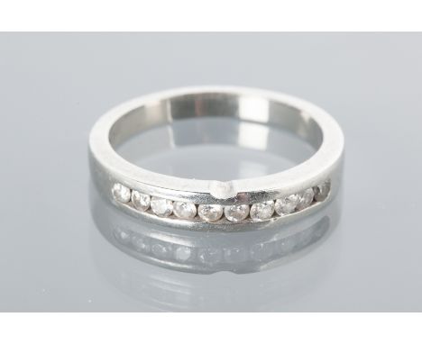 PLATINUM DIAMOND HALF ETERNITY RING
with channel set brilliant cut diamonds totalling very approximately 0.35 carats, size O