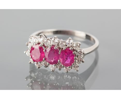 RUBY AND DIAMOND CLUSTER RING
set with three oval rubies each 5x4mm, in eighteen carat white gold