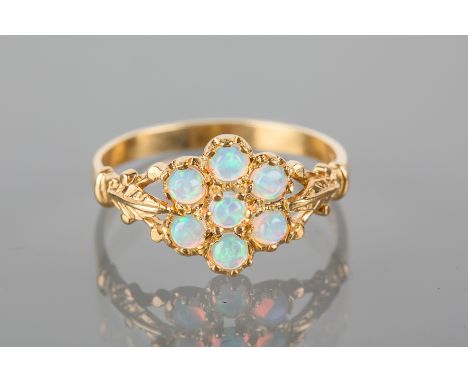 OPAL SIMULANT DRESS RING
the daisy cluster motif set with round cabochon stones, on engraved trifurcated shoulders, gold plat