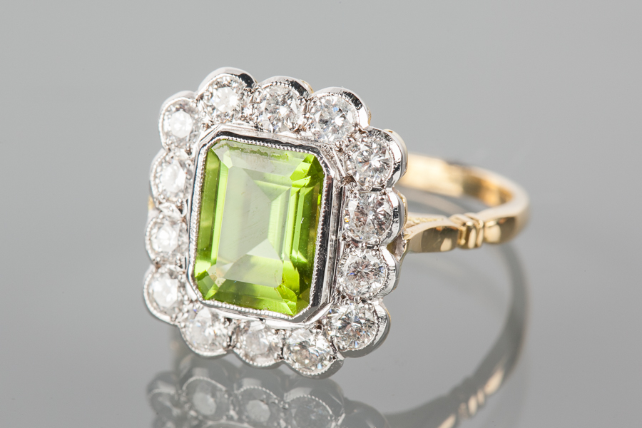 IMPRESSIVE PERIDOT AND DIAMOND CLUSTER RING the central emerald cut ...