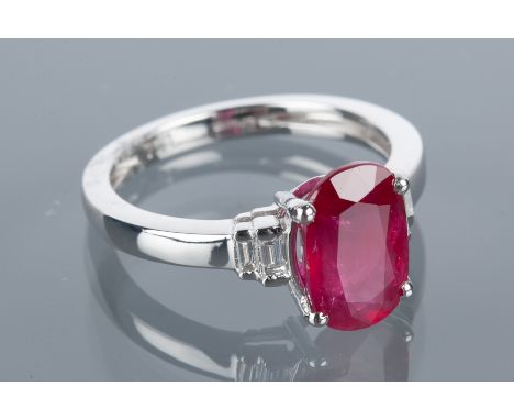 RUBY AND DIAMOND RING
the oval ruby of approximately 3.01 carats on baguette cut diamond set shoulders, in eighteen carat whi