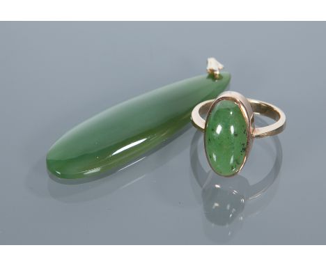 JADE PENDANT
set with a pear shaped section of darker green jade; along with a jade set ring (2)