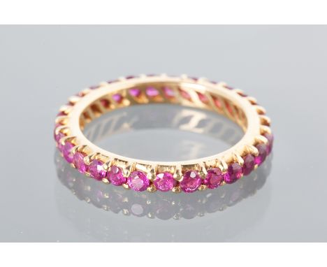 RUBY SET FULL ETERNITY RING
with circular rubies, in high carat gold gold, with maker's mark MC