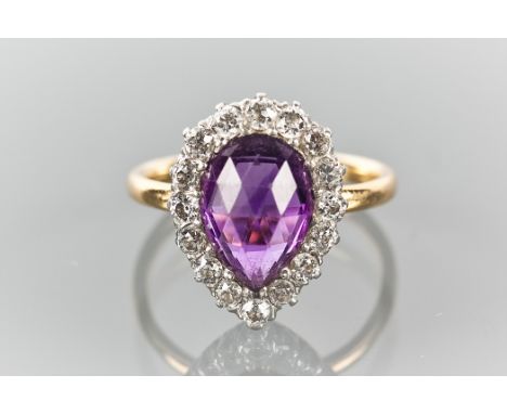 EARLY TWENTIETH CENTURY AMETHYST AND DIAMOND CLUSTER RING
with a pear shaped amethyst surrounded by brilliant cut diamonds, s