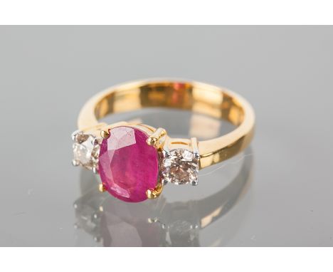 RUBY AND DIAMOND THREE STONE RING
the central oval ruby 9x6.5mm, flanked by two brilliant cut diamonds, in eighteen carat gol