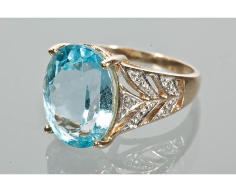 TOPAZ DRESS RING
the large oval topaz 16x12mm, on pierced shoulders, in nine carat gold, size O-P