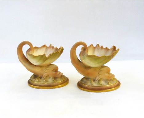 Pair of Victorian Royal Worcester porcelain shell dishes, each with exotic fish support, in shades of peach, cream and green 