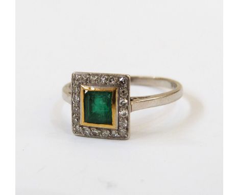 Platinum, diamond and emerald ring of Art Deco-style, the step-cut rectangular emerald within surround of 20 tiny diamonds (w