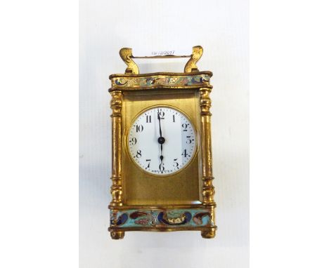 Late 19th/early 20th century French small enamel brass carriage timepiece, having scroll handles, serpentine sides, with scro
