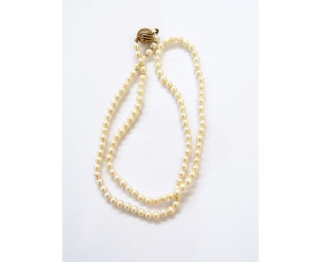 Cultured pearl single strand necklace and the silver gilt pierced whorl-pattern spherical clasp, 46cm 