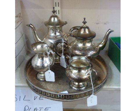 Silver plated four-piece tea service on a circular tray 